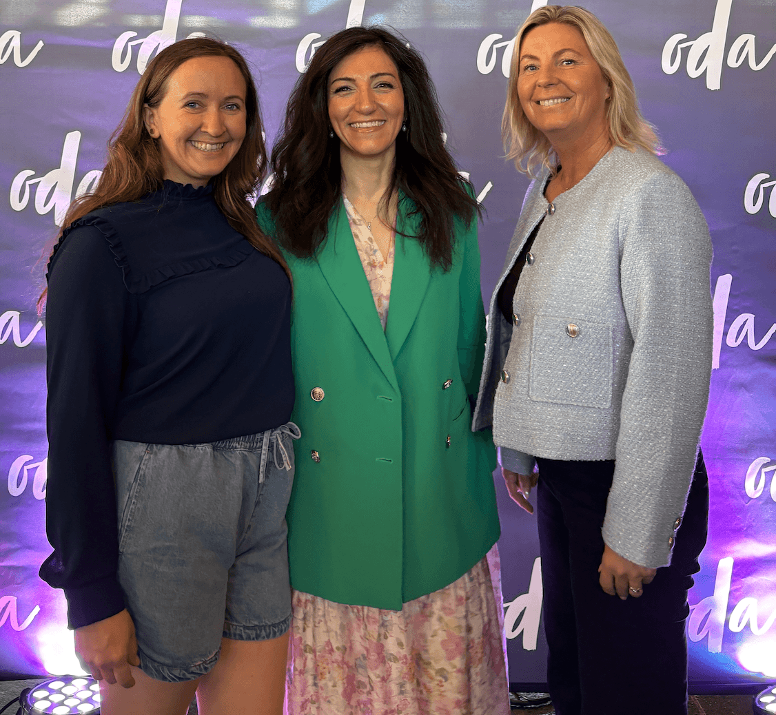 Three people smiling at the camera