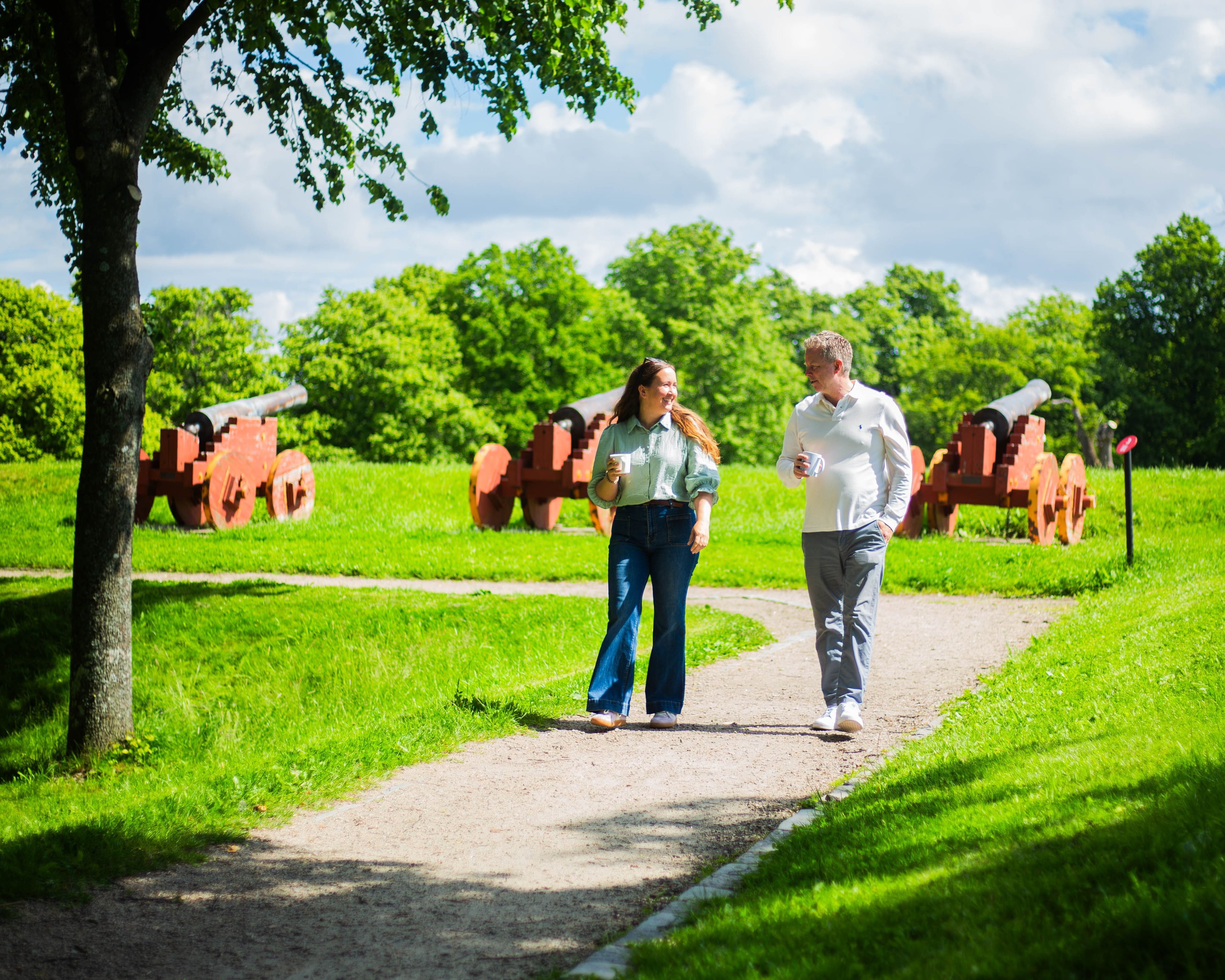 Two colleagues walking along the path on a summer day