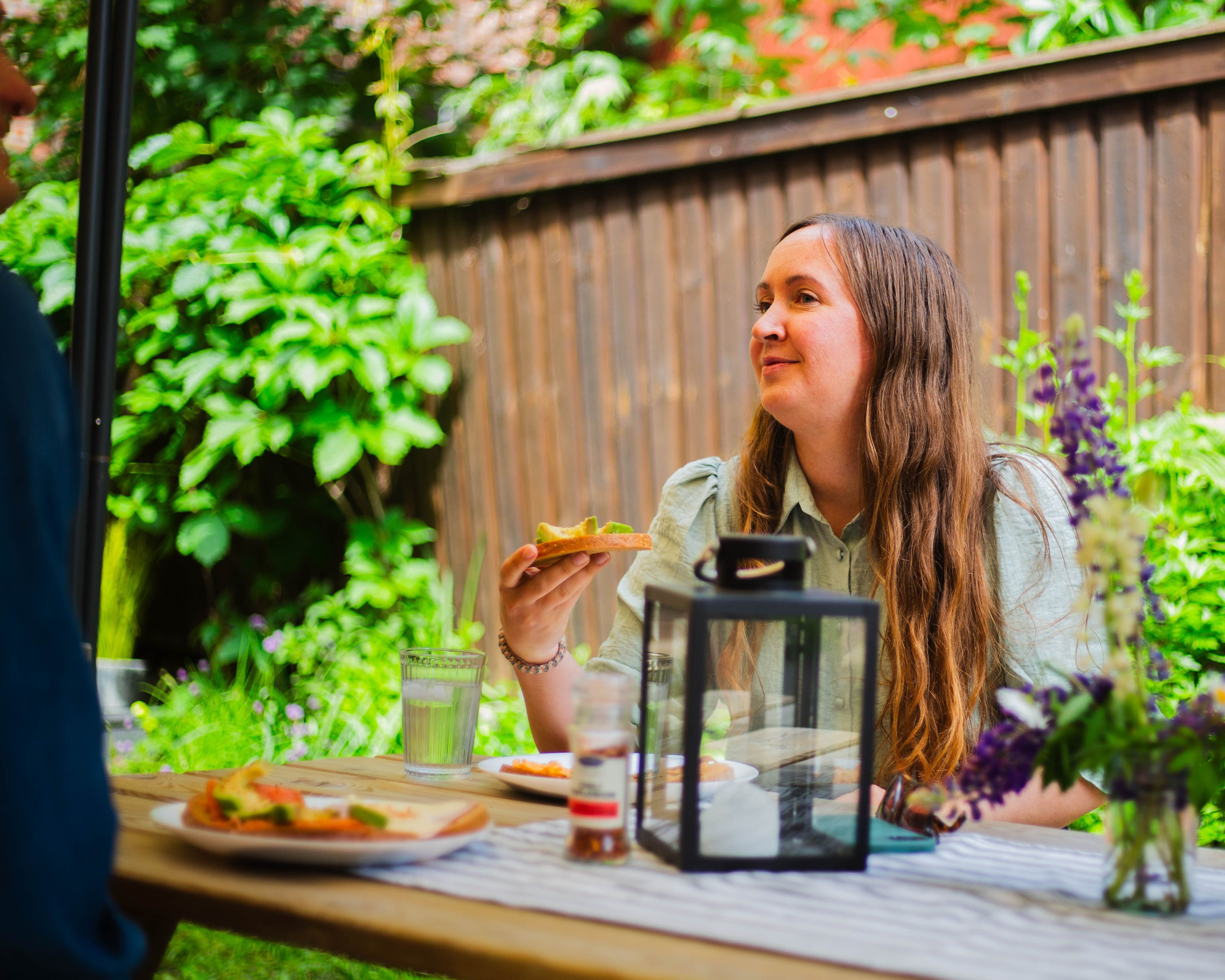 Colleague at a set table outdoors in the summer sun