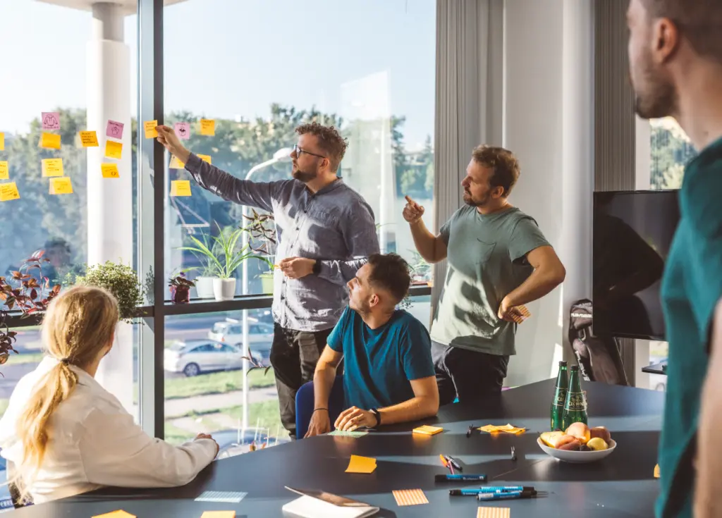 5 people doing workshop with sticky notes